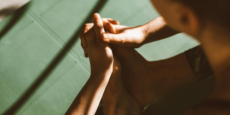 Close-up of a person's hands in a graceful yoga mudra.